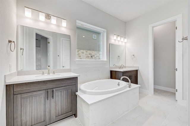 bathroom with dual sinks, a relaxing tiled bath, vanity with extensive cabinet space, and tile flooring