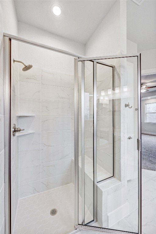 bathroom featuring ceiling fan and walk in shower