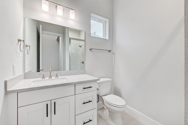 bathroom with tile floors, toilet, and vanity