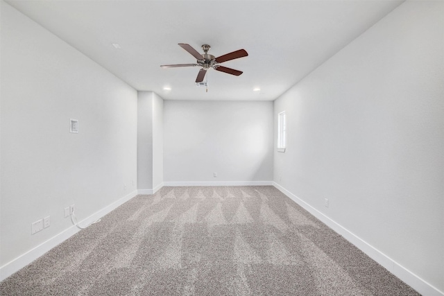 carpeted spare room with ceiling fan