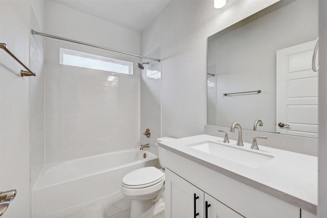 full bathroom featuring vanity, tile floors, toilet, and tiled shower / bath