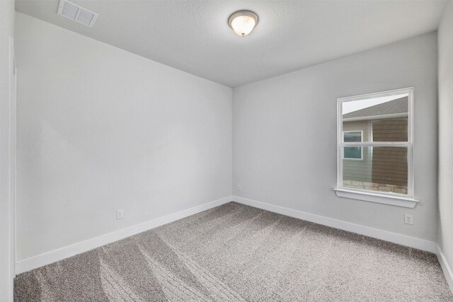 empty room featuring light carpet