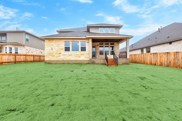 rear view of house with a lawn