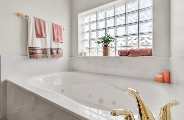 bathroom featuring a washtub and a healthy amount of sunlight