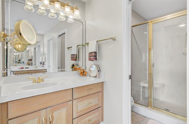 bathroom featuring walk in shower, tile flooring, vanity with extensive cabinet space, and toilet