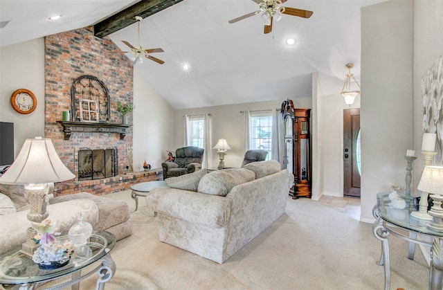 living room featuring beam ceiling, ceiling fan, a brick fireplace, and light colored carpet