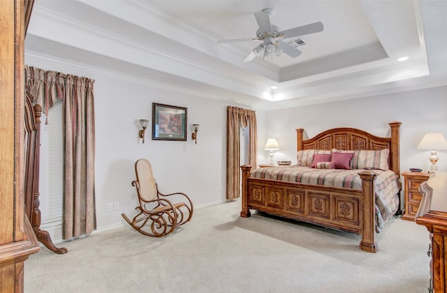 bedroom with ceiling fan, ornamental molding, a tray ceiling, and light carpet