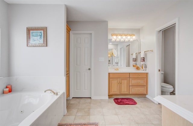 bathroom featuring a bathtub, toilet, vanity with extensive cabinet space, and tile flooring