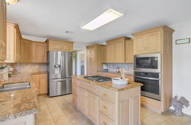 kitchen featuring light tile floors, a center island, tasteful backsplash, and stainless steel appliances