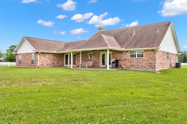 back of house featuring central AC, a patio area, and a yard