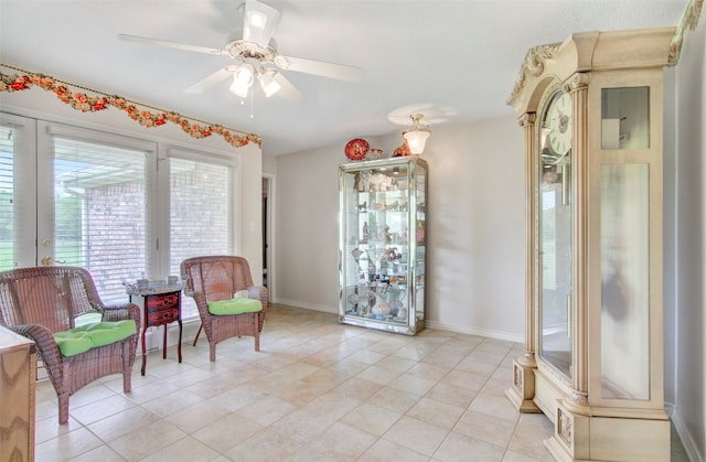 living area featuring ceiling fan and light tile floors