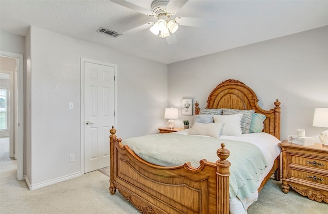 bedroom featuring light colored carpet and ceiling fan