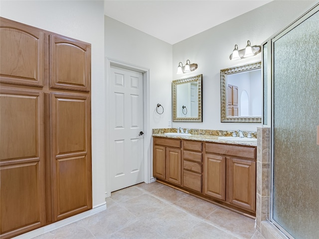 bathroom featuring a shower with door, tile patterned flooring, and dual bowl vanity