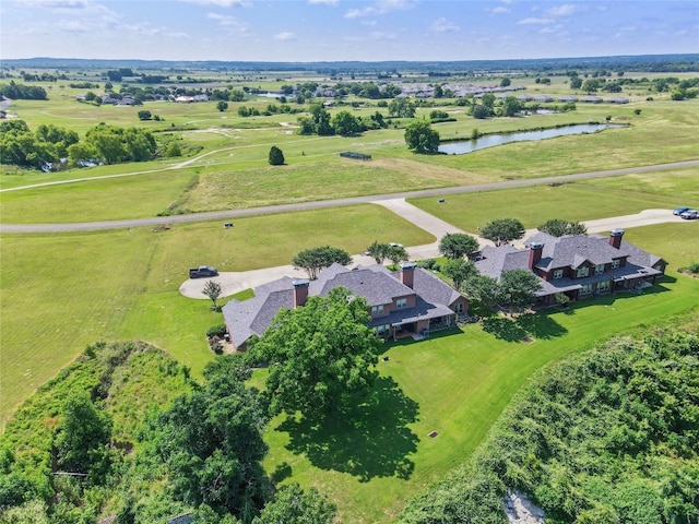 birds eye view of property featuring a water view and a rural view