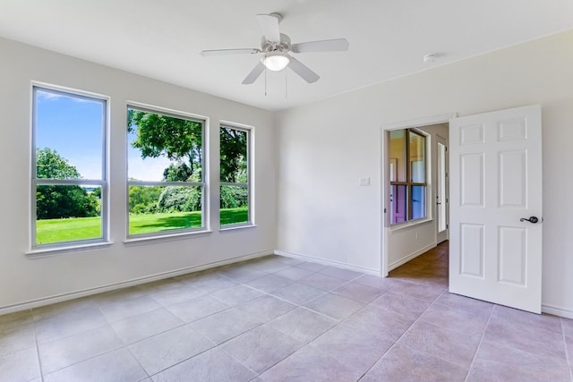 spare room with light tile patterned flooring and ceiling fan