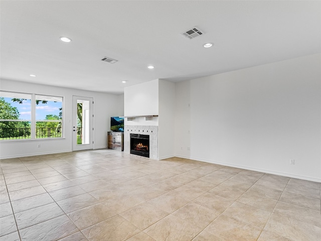 unfurnished living room with recessed lighting, baseboards, a fireplace, and visible vents