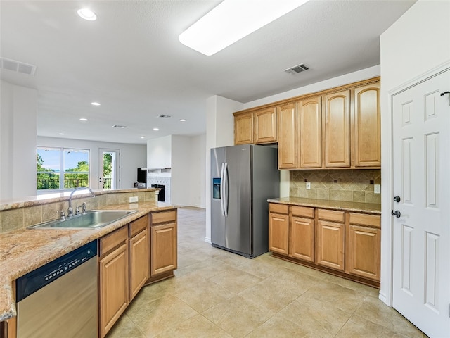 539 Colovista Pkwy Unit C101, Bastrop, TX 78602 - kitchen with appliances with stainless steel finishes, a sink, tasteful backsplash, recessed lighting, and light stone countertops
