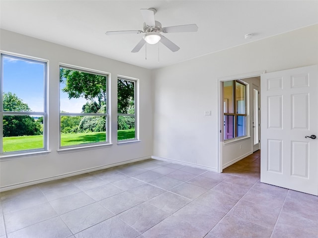 539 Colovista Pkwy Unit C101, Bastrop, TX 78602 - unfurnished room with light tile patterned floors, ceiling fan, a smoke detector, and baseboards