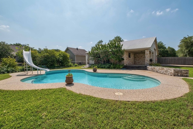 view of pool with a patio, a yard, and a water slide