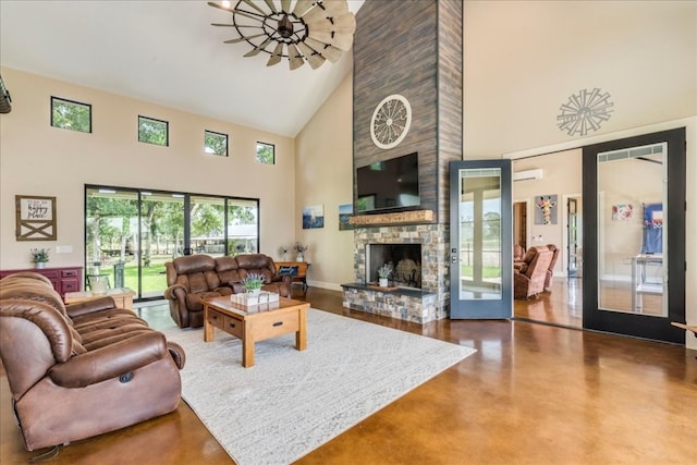 living room featuring an AC wall unit, high vaulted ceiling, french doors, and a fireplace