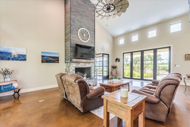 living room featuring a fireplace and a towering ceiling