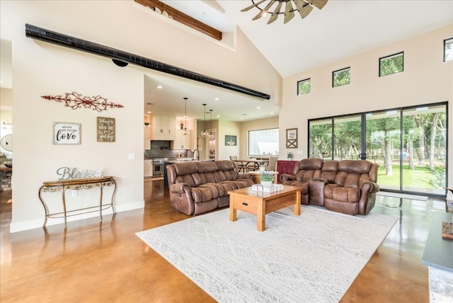 living room featuring high vaulted ceiling, sink, and a wealth of natural light