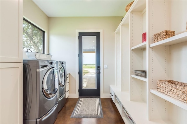 clothes washing area with washing machine and dryer