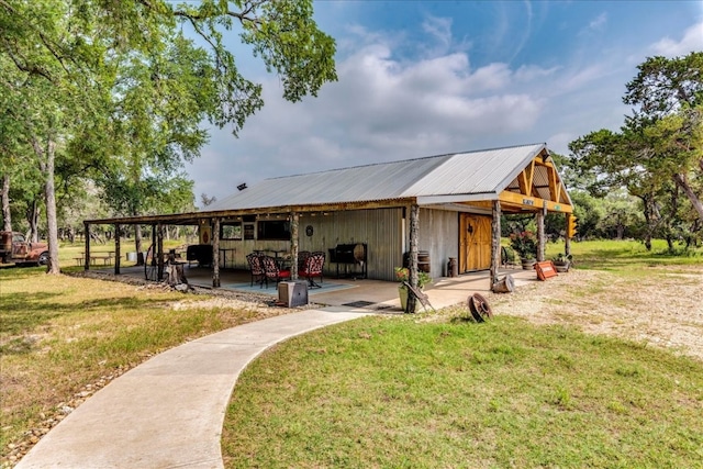 view of property's community featuring a yard and a patio area