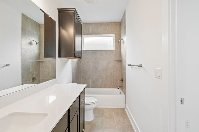 full bathroom featuring vanity, toilet, tiled shower / bath combo, and tile patterned floors