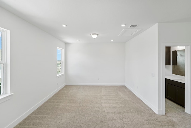 empty room with plenty of natural light and light carpet