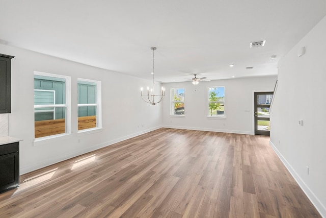 interior space featuring ceiling fan with notable chandelier and wood-type flooring