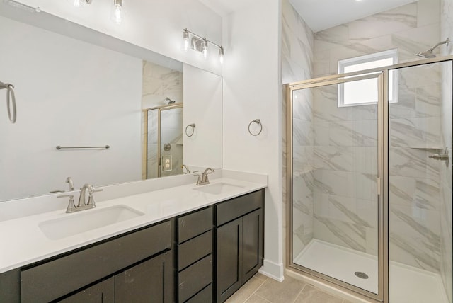 bathroom featuring tile patterned flooring, a shower with shower door, and vanity