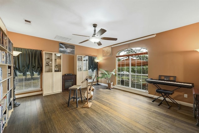 interior space featuring ceiling fan and dark wood-type flooring