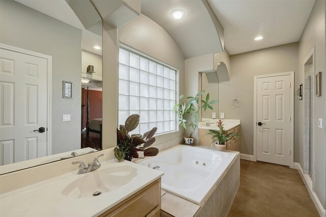 bathroom with vanity and independent shower and bath