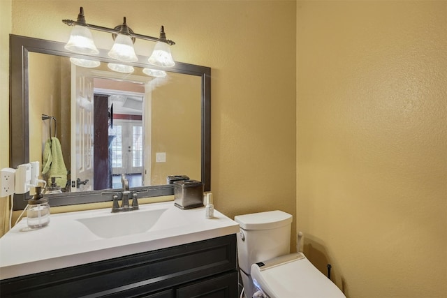 bathroom featuring vanity and toilet