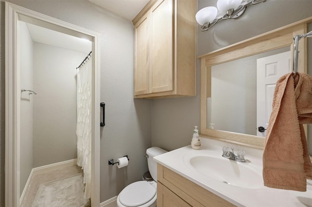 bathroom featuring vanity, toilet, and curtained shower