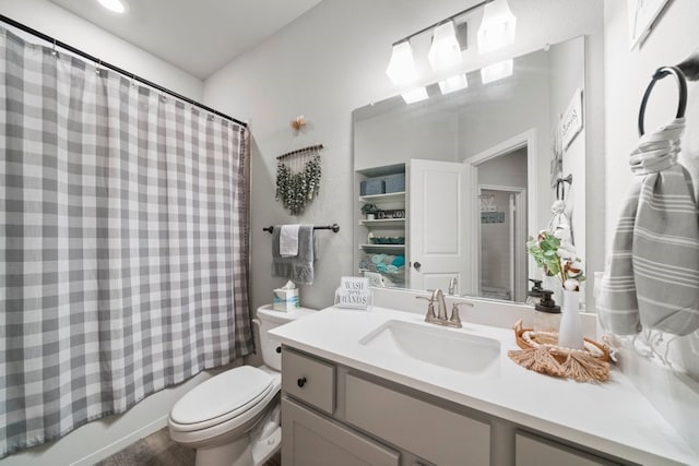 full bathroom with shower / bath combo with shower curtain, toilet, hardwood / wood-style flooring, and oversized vanity