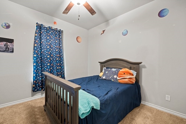 bedroom featuring ceiling fan and dark carpet