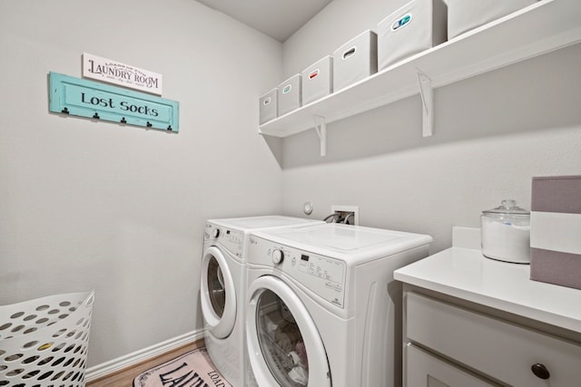 laundry area with washer hookup, washer and clothes dryer, and light hardwood / wood-style flooring