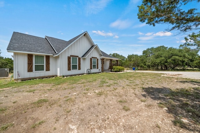 modern inspired farmhouse featuring central air condition unit and a front lawn