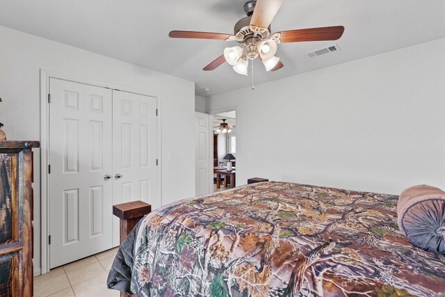 tiled bedroom with a closet and ceiling fan