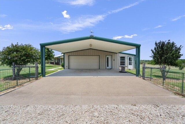 garage featuring a yard and a carport