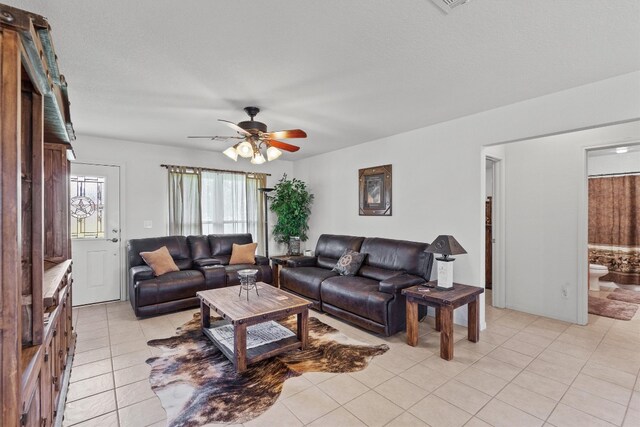 living room with ceiling fan and light tile patterned floors