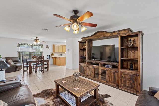 tiled living room with ceiling fan