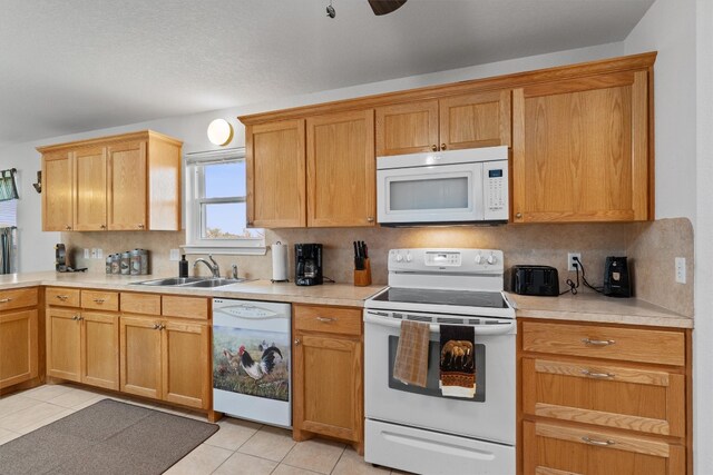 kitchen featuring white appliances, tasteful backsplash, sink, ceiling fan, and light tile patterned flooring