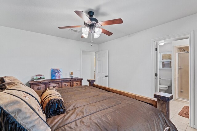 tiled bedroom with ceiling fan and ensuite bath