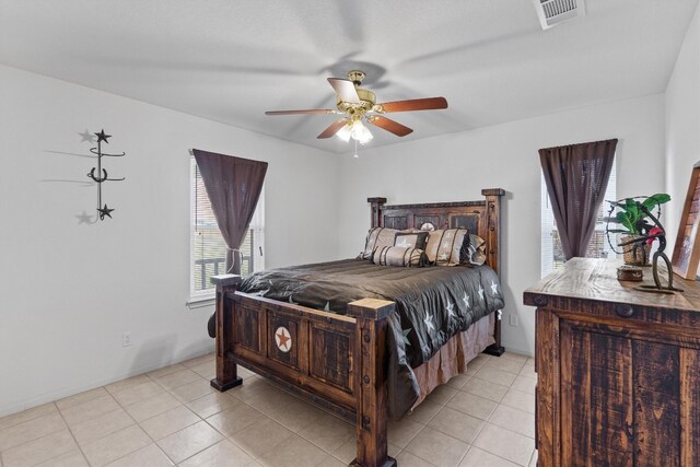 tiled bedroom featuring ceiling fan