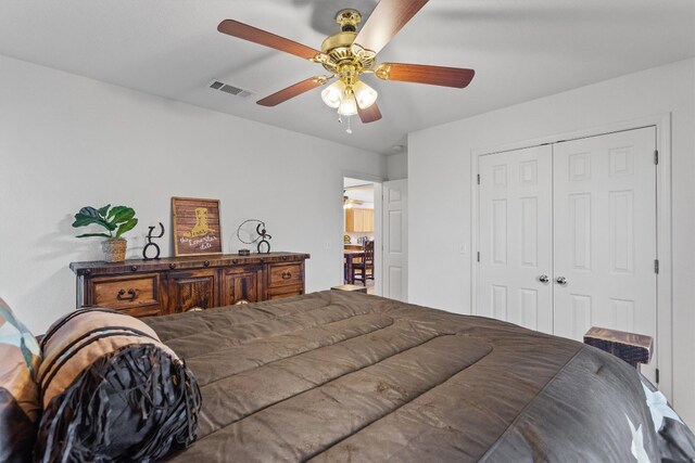 bedroom with ceiling fan and a closet