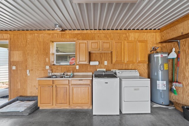 kitchen with sink, independent washer and dryer, wooden walls, and water heater