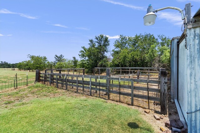 view of yard with a rural view